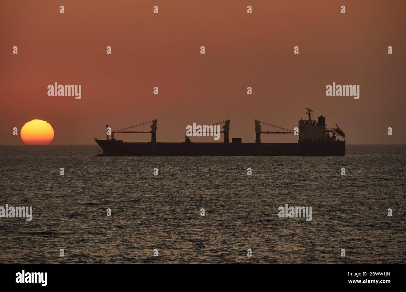 Ship on the sea at sunset, Walvis Bay, Namibia Stock Photo