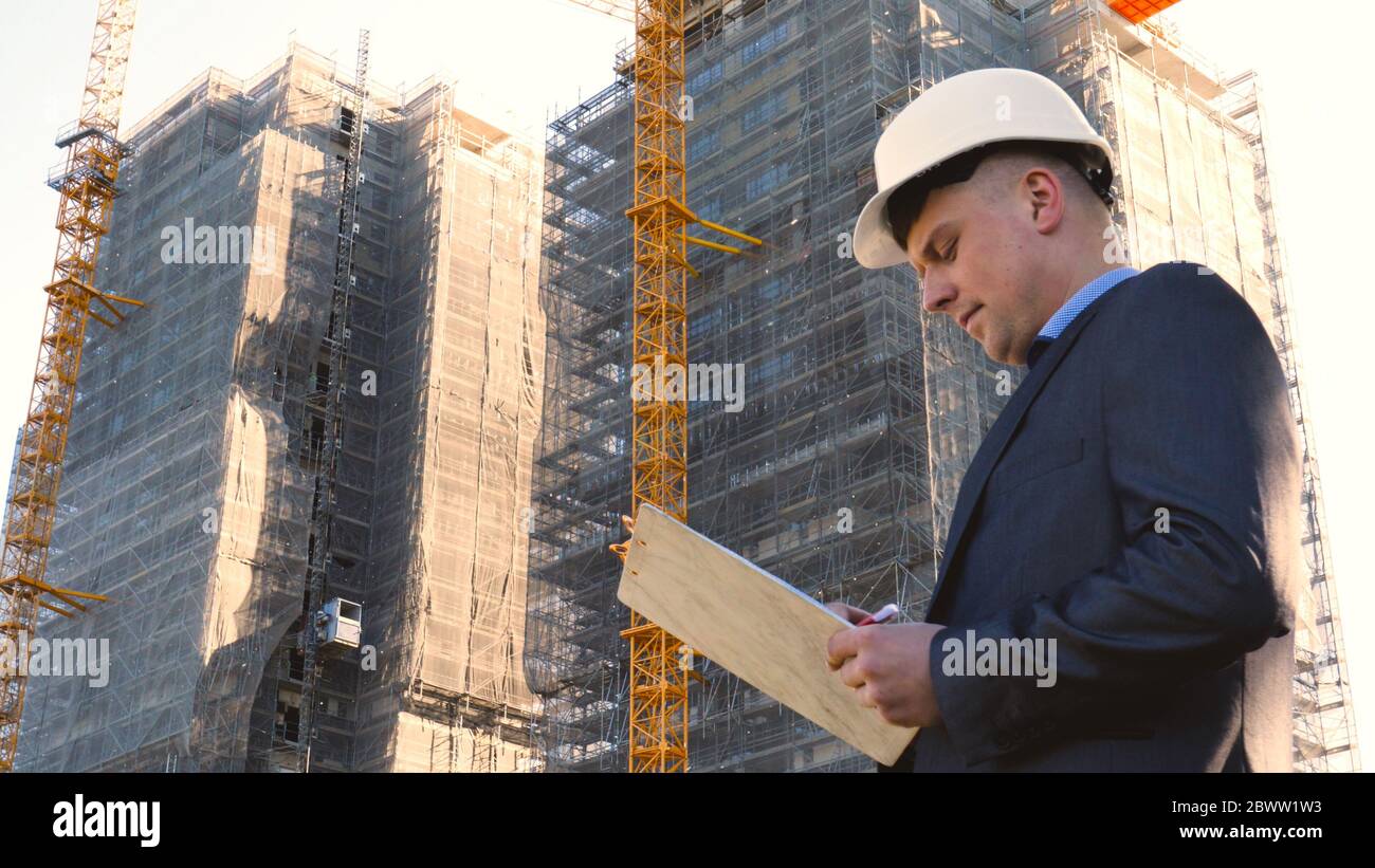 Portrait of a successful young handsome engineer, architect, builder ...