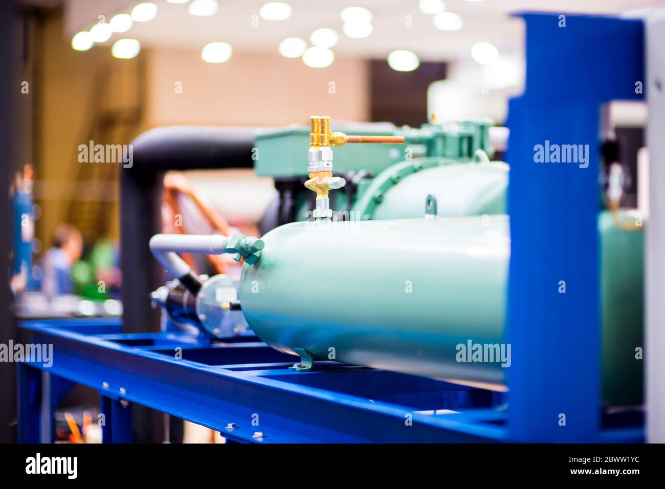Industrial stainless steel piping connected by special nuts. Cooling system element for the food industry. Stock Photo
