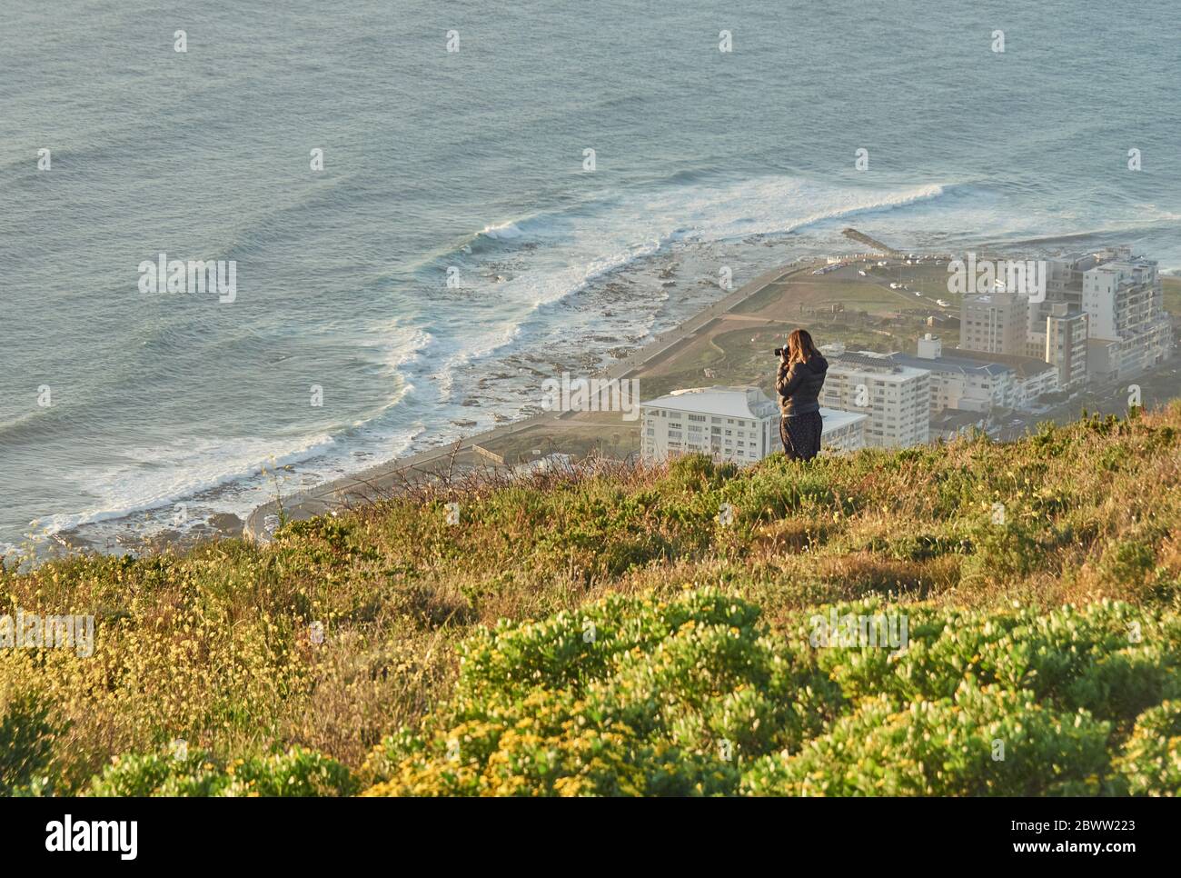 Woman taking pictures from the top of a hill, Signal Hill, South Africa Stock Photo