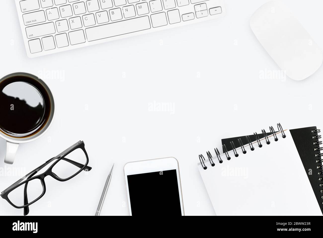 White office desk with supplies. Top view with copy space; flat lay ...