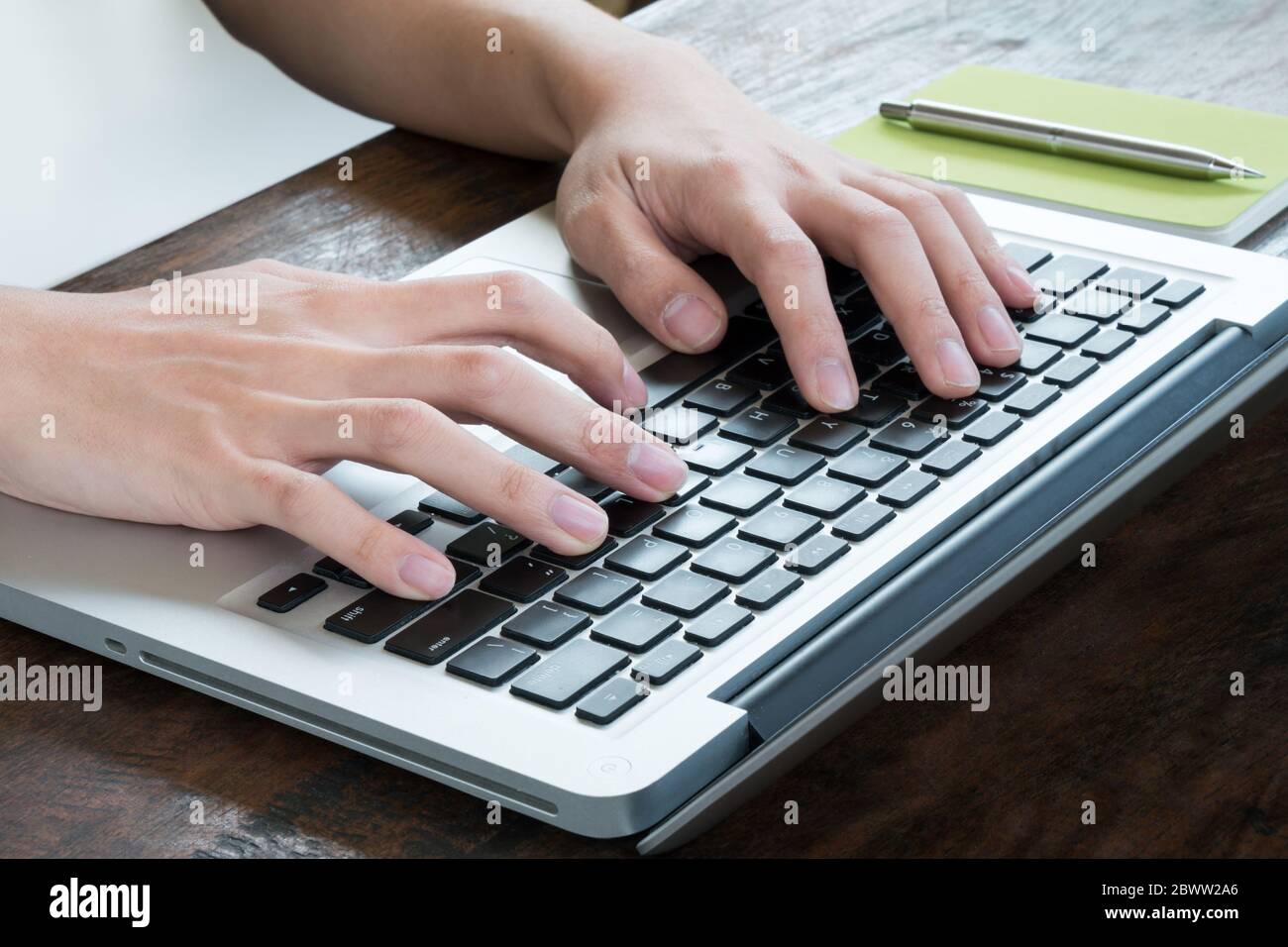 Man is typing on laptop keyboard. Stock Photo