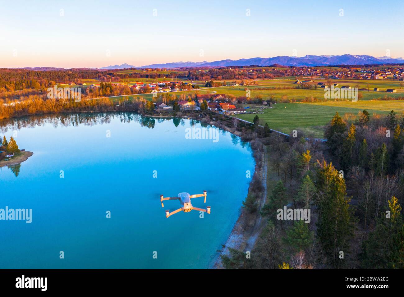 Germany, Bavaria, Konigsdorf, Drone flying over Bibisee at dusk Stock Photo