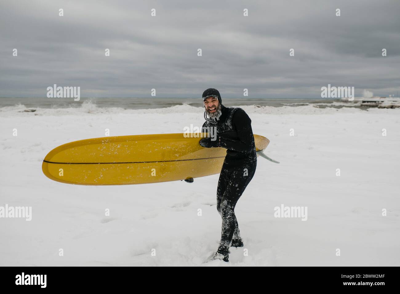 Surfer with surfboard in snow in Ontario, Canada Stock Photo Alamy