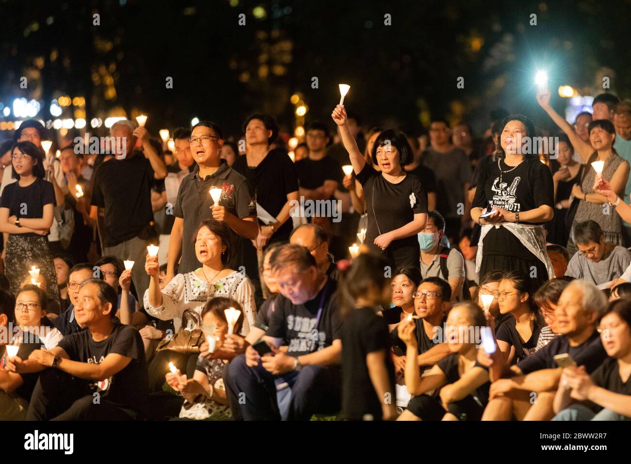 A crowd reflecting during a Candlelit Vigil for victims of the Tiananmen Square Massacre in Victoria Park, Hong Kong - 4th June 2019 Stock Photo