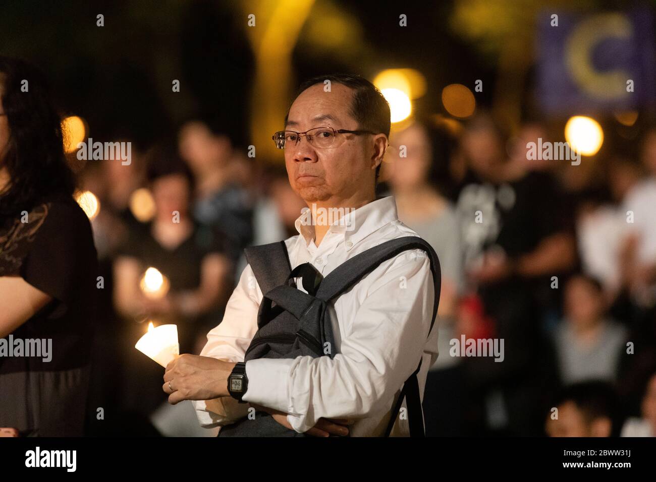 A man appearing sad while reflecting during a Candlelit Vigil for victims of the Tiananmen Square Massacre in Victoria Park, Hong Kong - 4th June 2019 Stock Photo