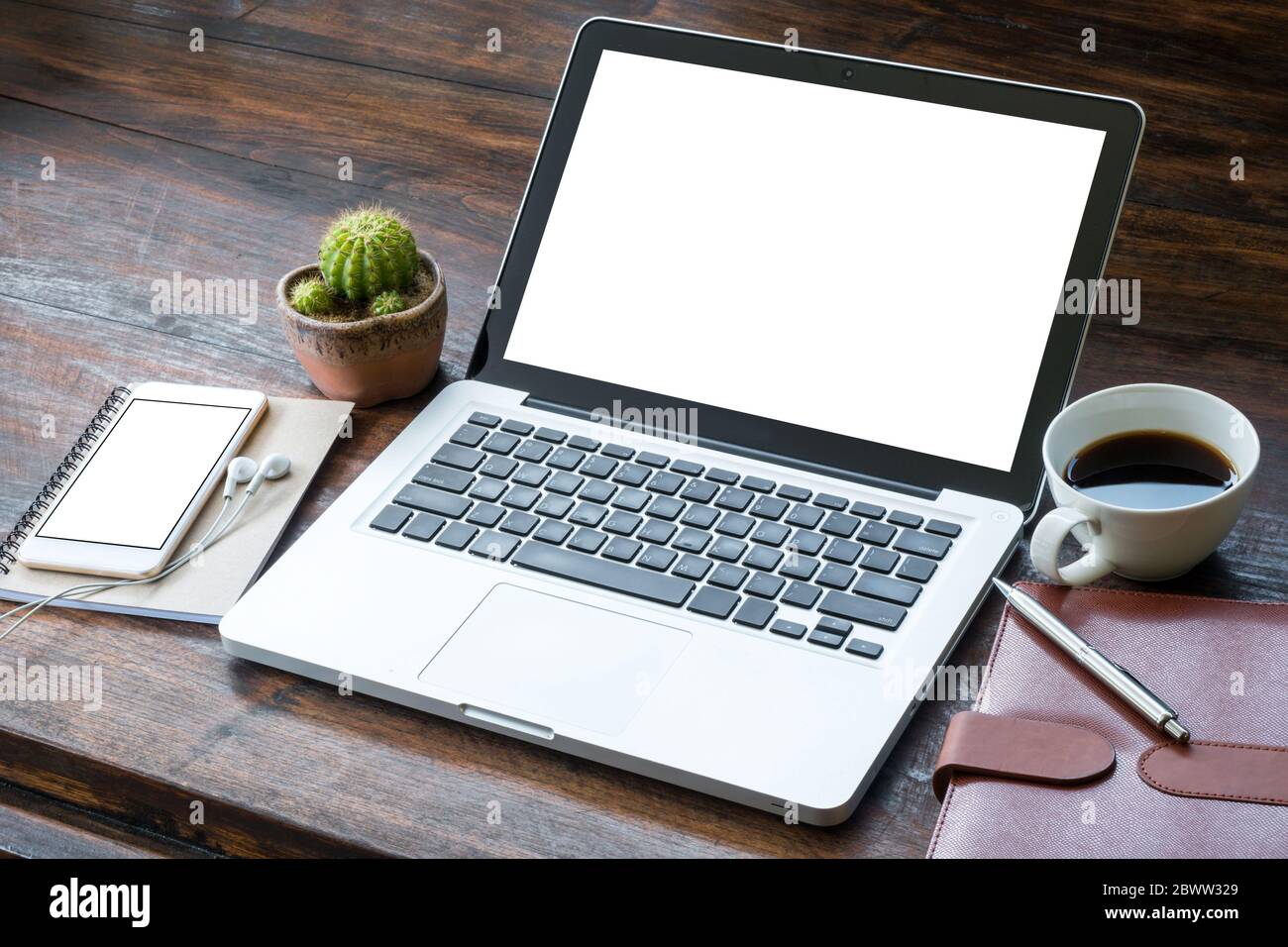 Laptop with white blank screen on the wood office table Stock Photo - Alamy