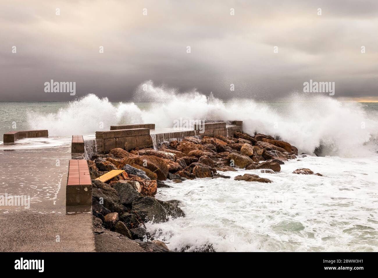 Italy Liguria Varigotti - Waves crash against the Varigotti pier Stock Photo