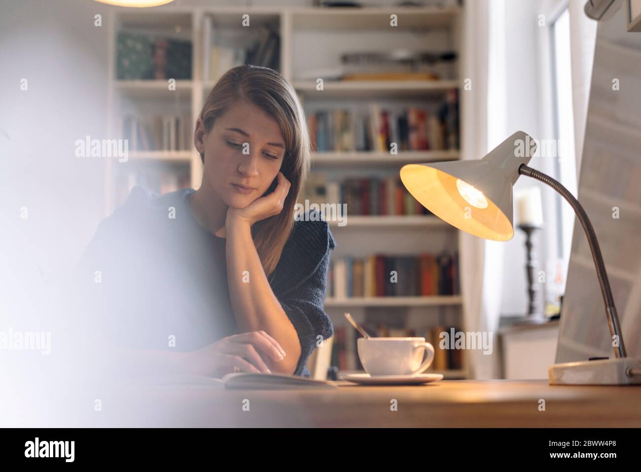 Woman reading book table hi-res stock photography and images - Alamy