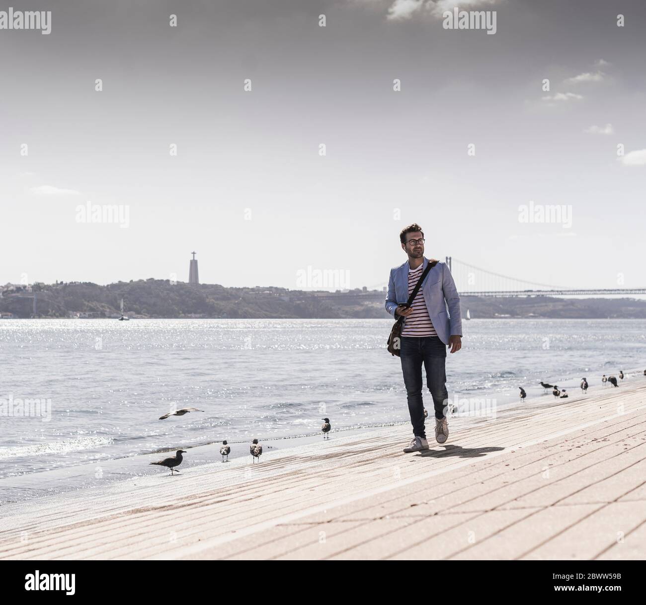 Young man walking by river hi-res stock photography and images - Alamy