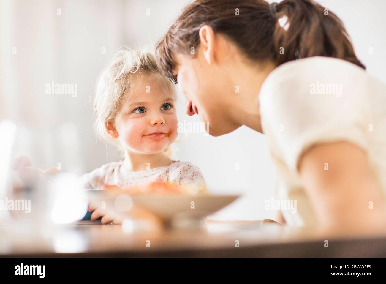 mother-and-daughter-during-dinner-at-home-stock-photo-alamy