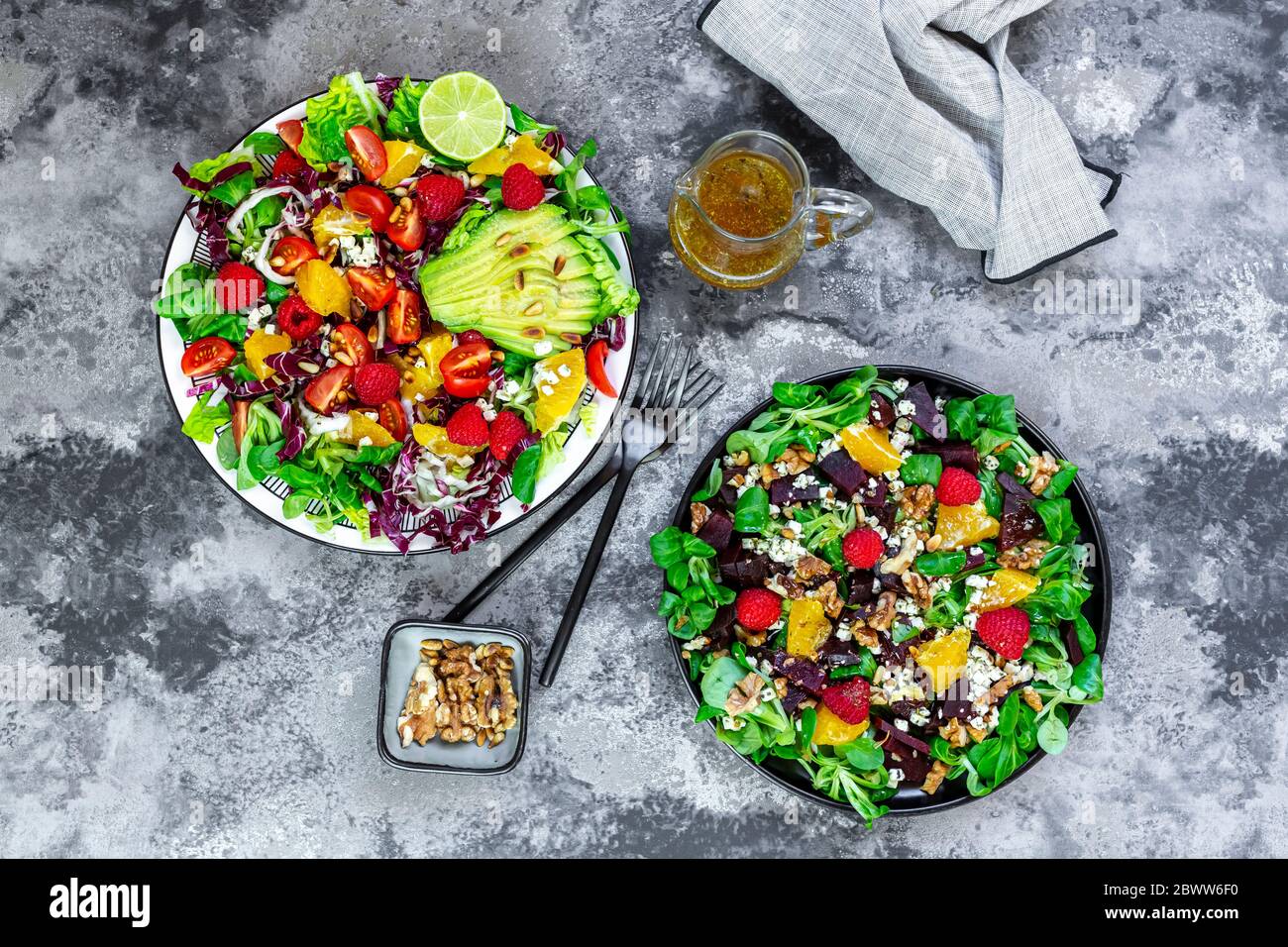 Two plates of mixed fruit-vegetable salads Stock Photo