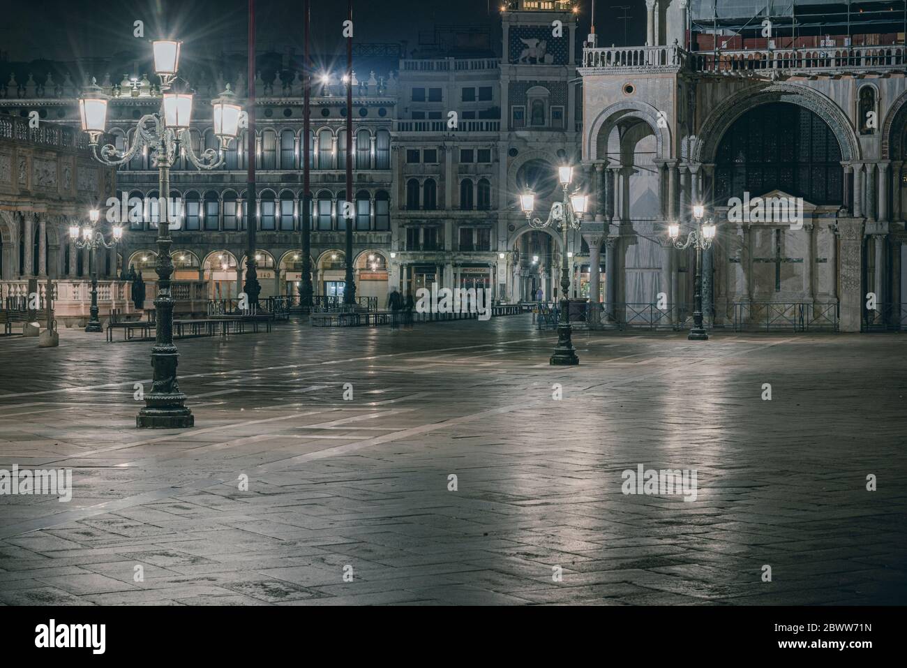 Italy, Venice, Street lights illuminating empty square at night Stock Photo