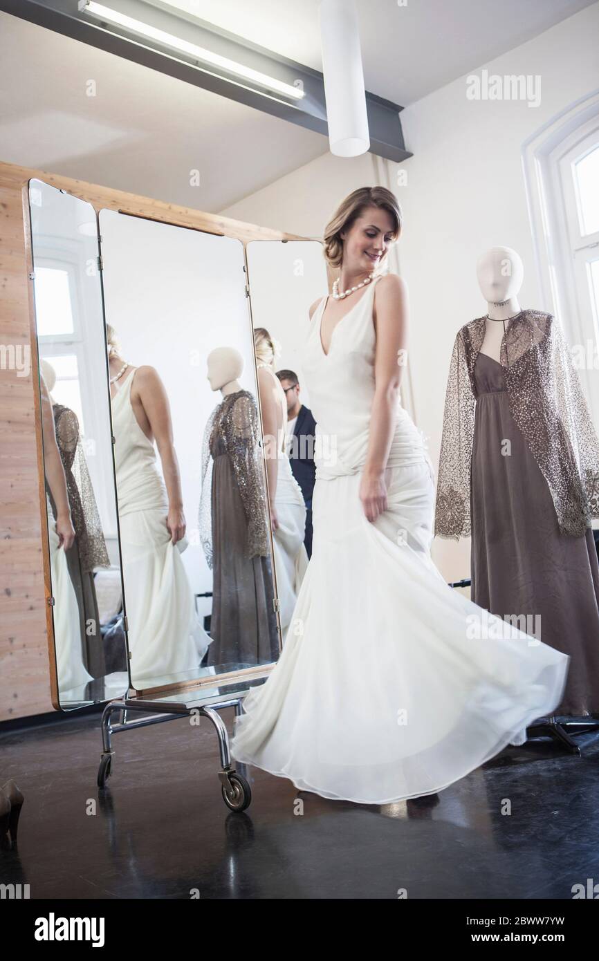 Bride fitting her dress in studio Stock Photo