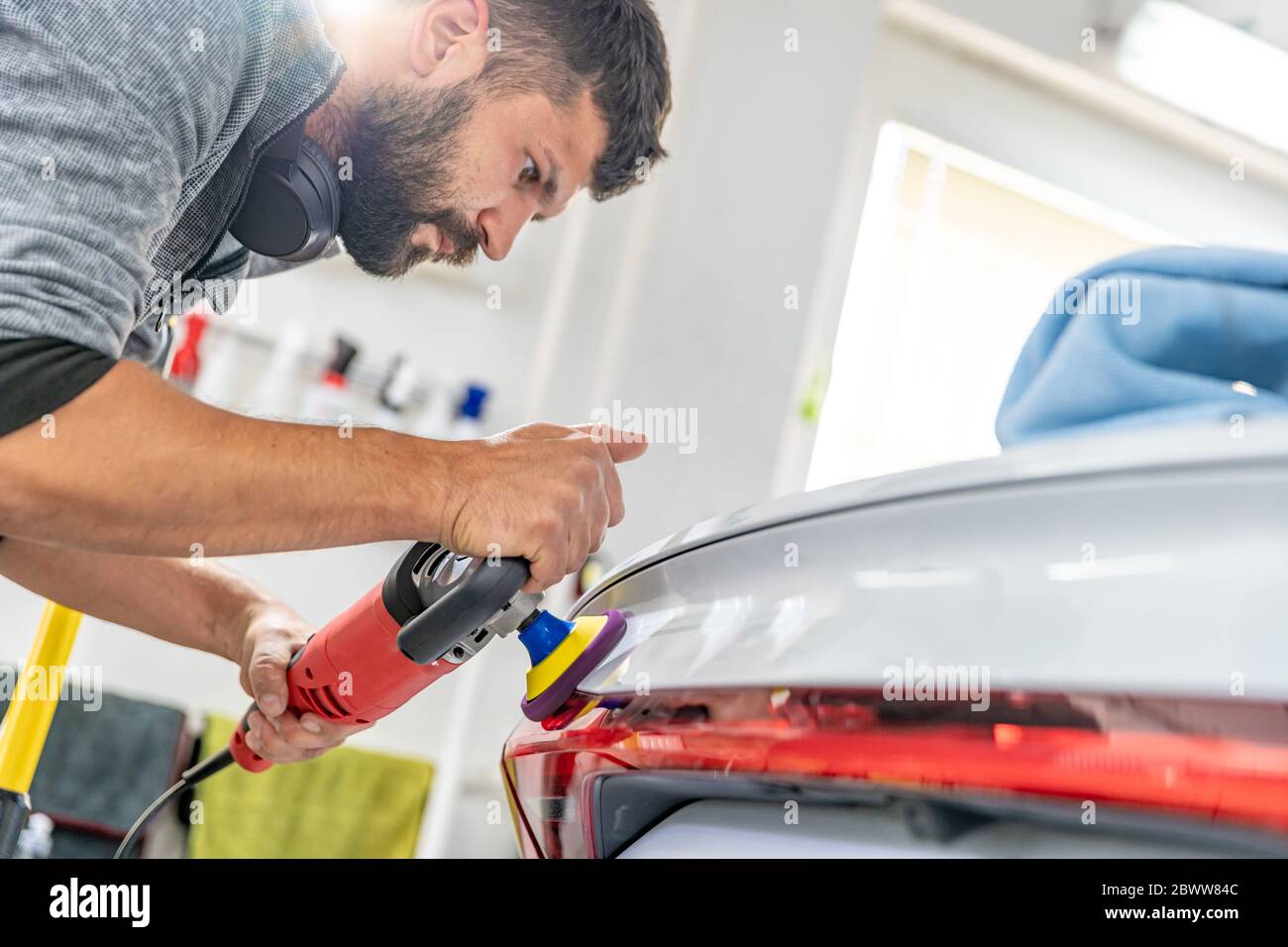 manual polishing of the body of luxury cars with the application of ceramic protective equipment Stock Photo