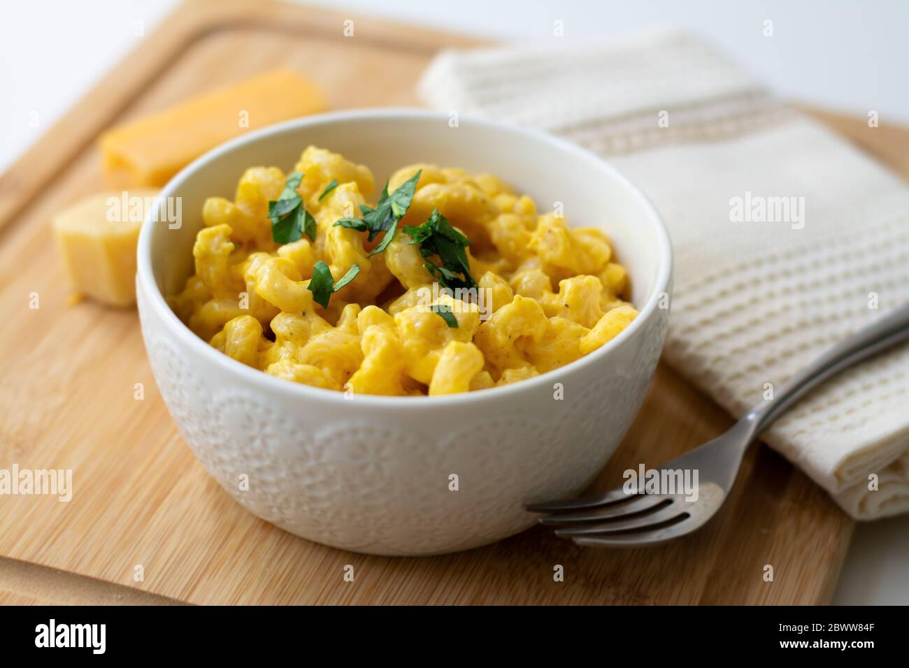Traditional American macaroni and cheese comfort food (also called mac n cheese) with elbow pasta coated in a cheesy creamy cheddar sauce. Stock Photo