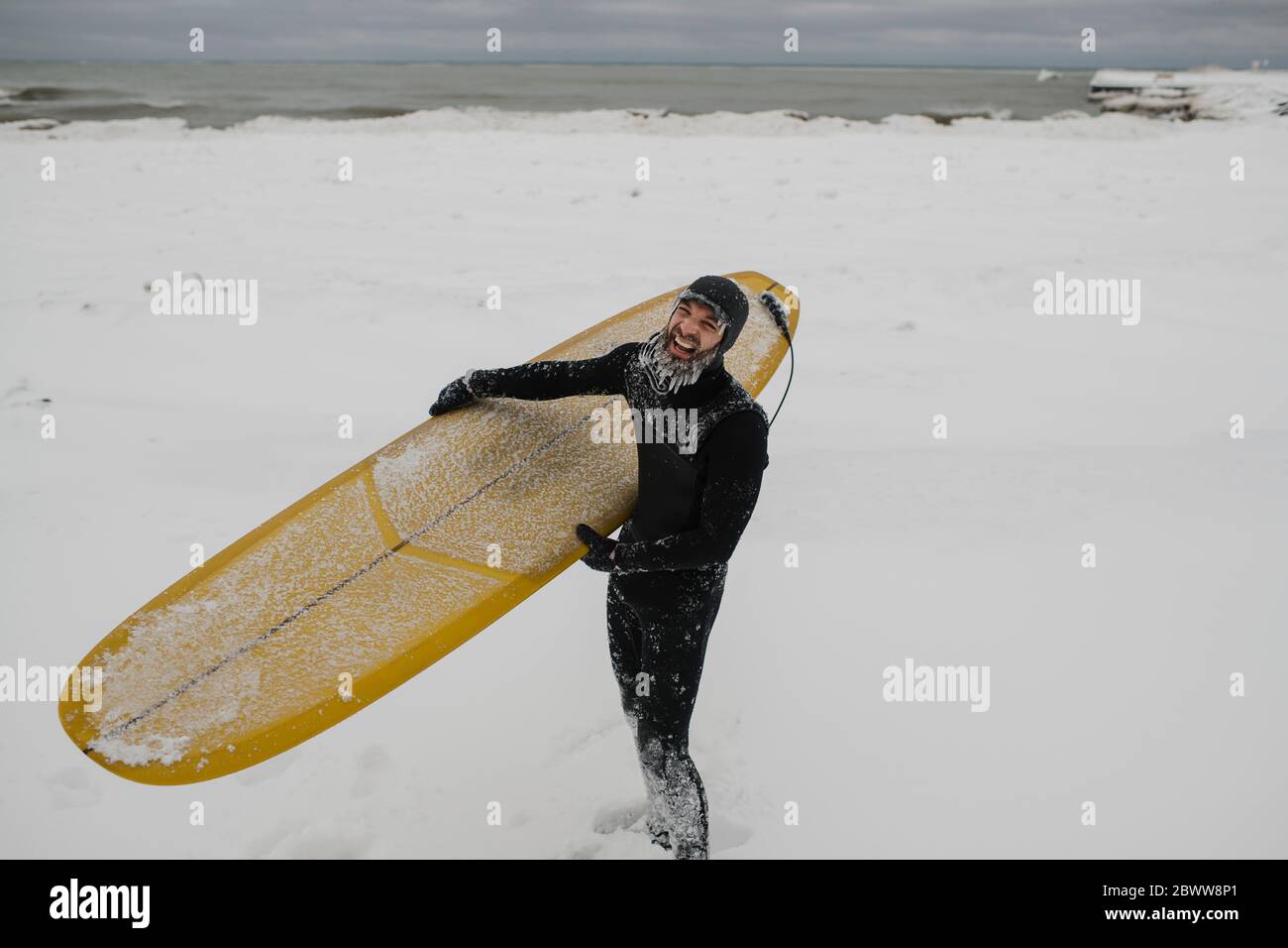 Surfer with surfboard in snow in Ontario, Canada Stock Photo Alamy