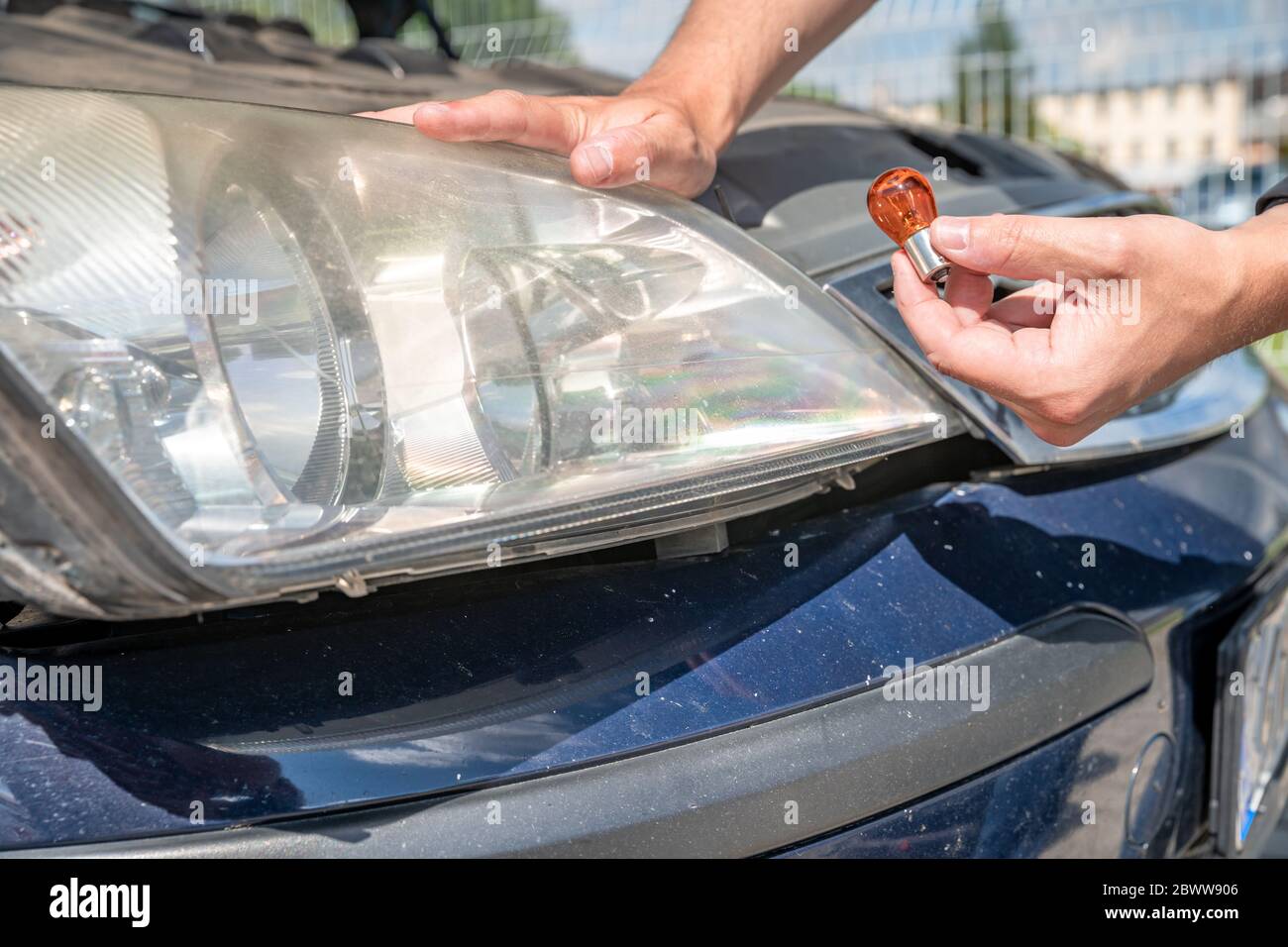 car headlight repair by replacing bad bulbs with new ones Stock Photo
