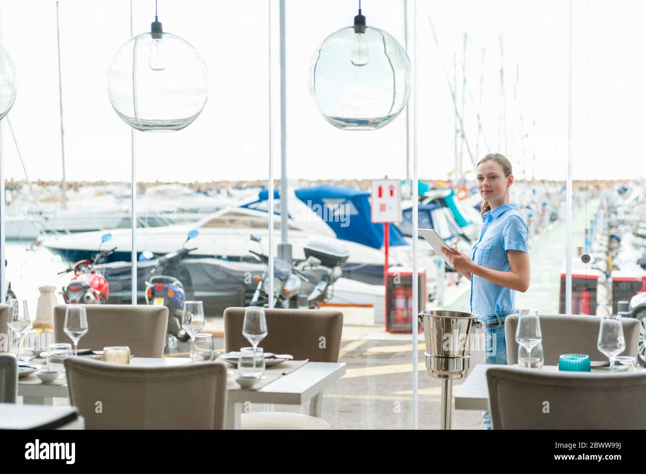 Portrait of woman with digital tablet at marina, Mallorca, Spain Stock Photo