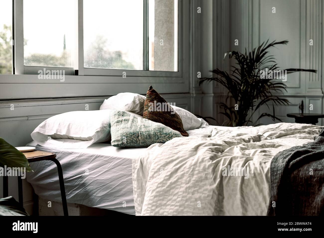 Unmade bed in a loft Stock Photo