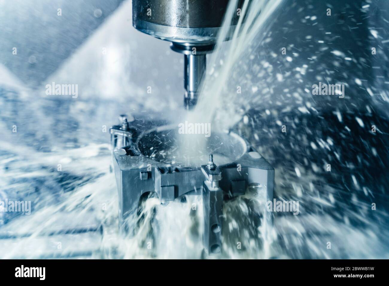 Germany, Close-up of water cooling down milling cutter Stock Photo