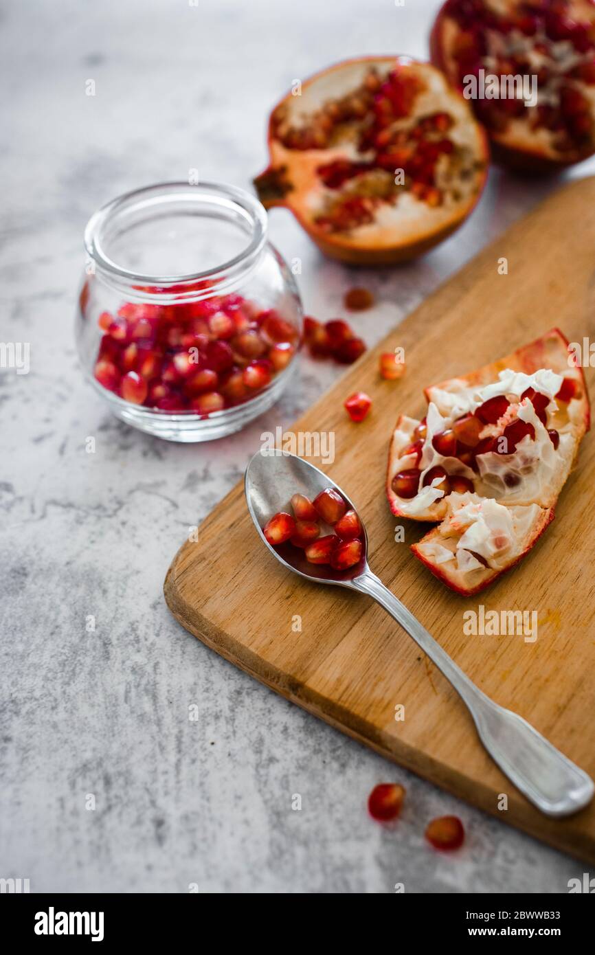 Teaspoon with fresh pomegranate seeds Stock Photo