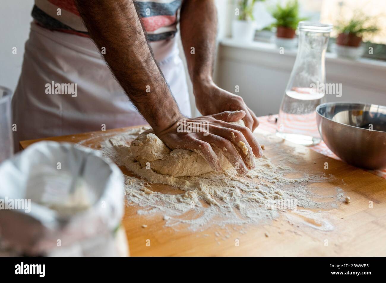 Crop view of man kneading dough Stock Photo
