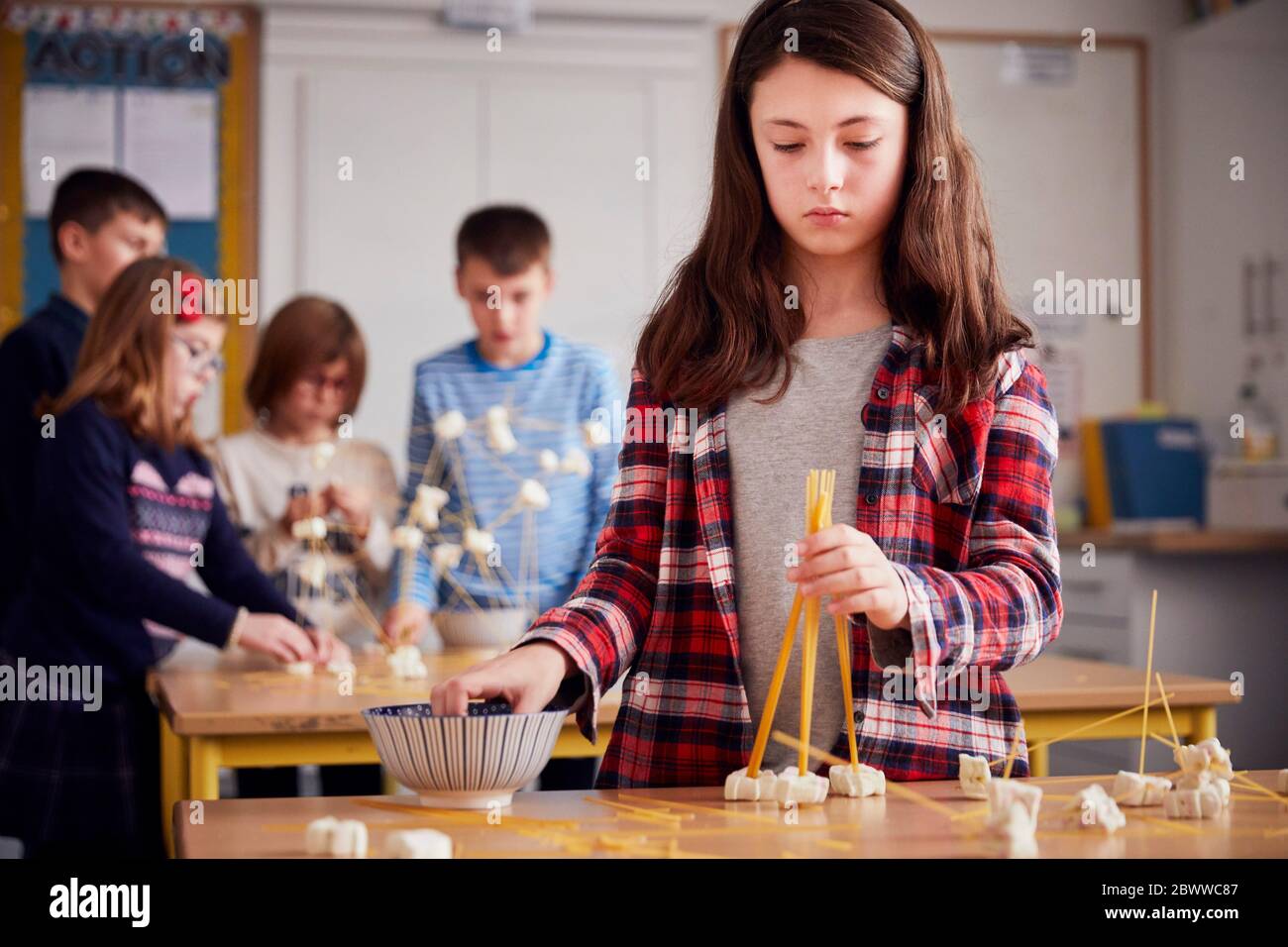 Girl setting up construction during a science lesson Stock Photo