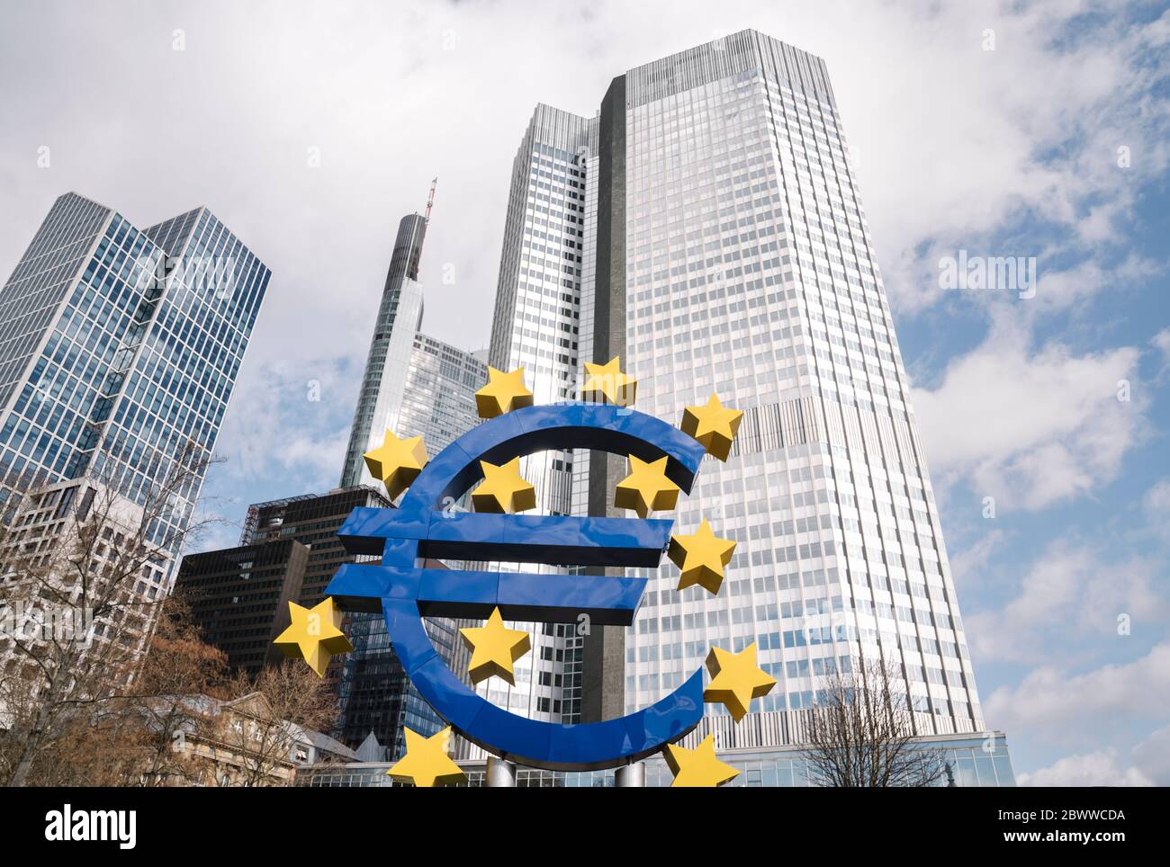 Germany, Hesse, Frankfurt, Low angle view of Euro-Skulptur with Eurotower in background Stock Photo