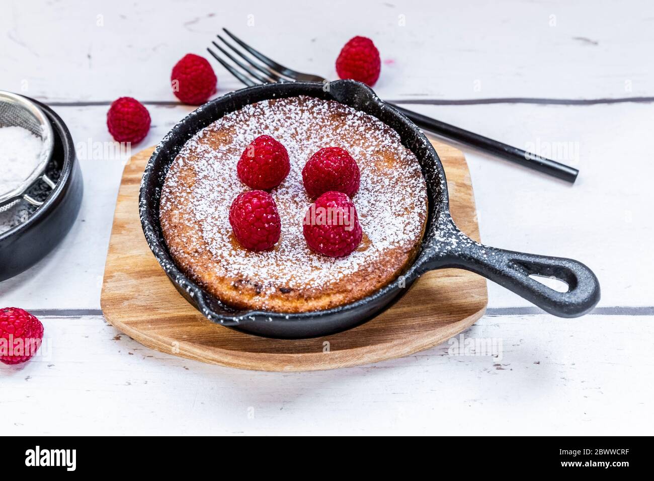 Dutch baby pancake with raspberries and powdered sugar Stock Photo