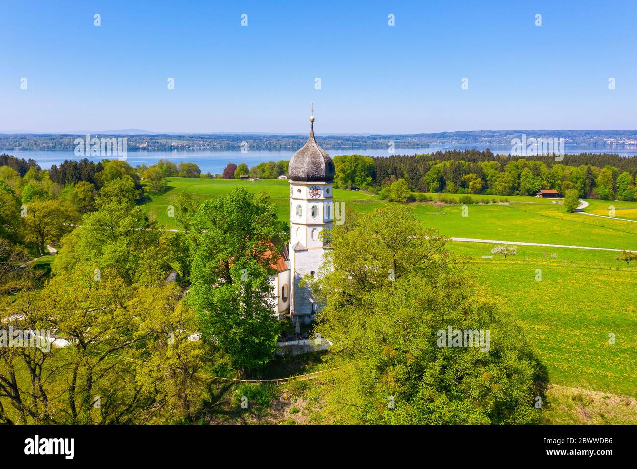 Germany, Bavaria, Munsing, Drone view of Church of Assumption of Virgin Mary in spring Stock Photo