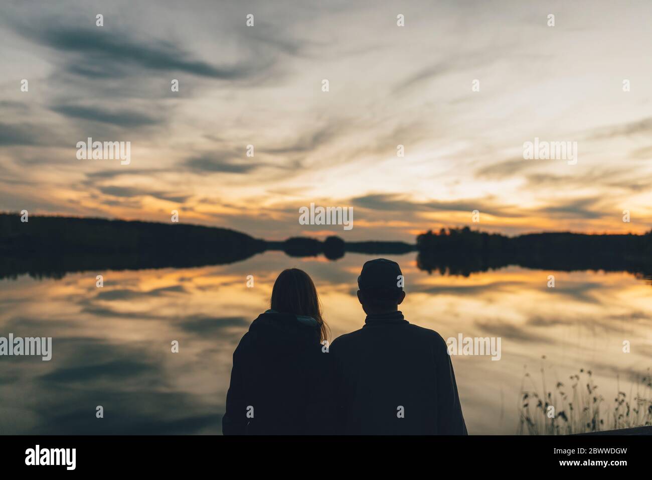 Two women watching the sunset hi-res stock photography and images - Alamy