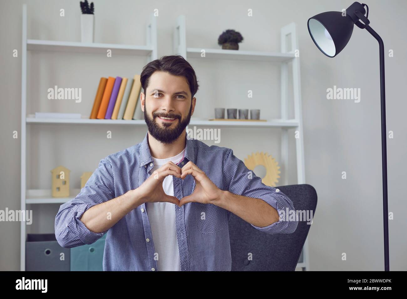 Online dating. Happy young guy showing heart with hands while communicating  to his lover through webcam Stock Photo - Alamy