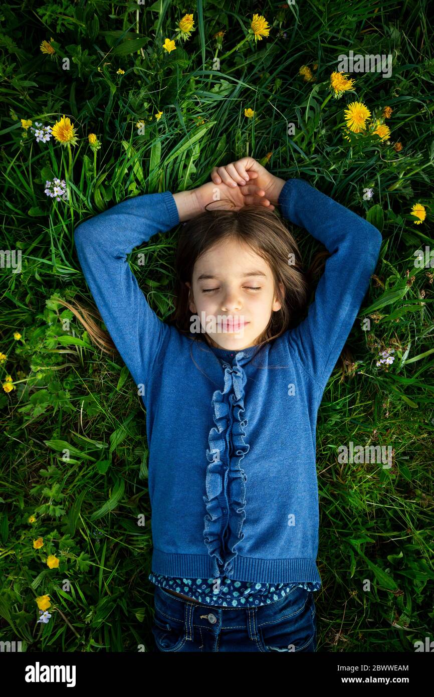 Portrait of girl with eyes closed relaxing on a meadow in spring Stock ...