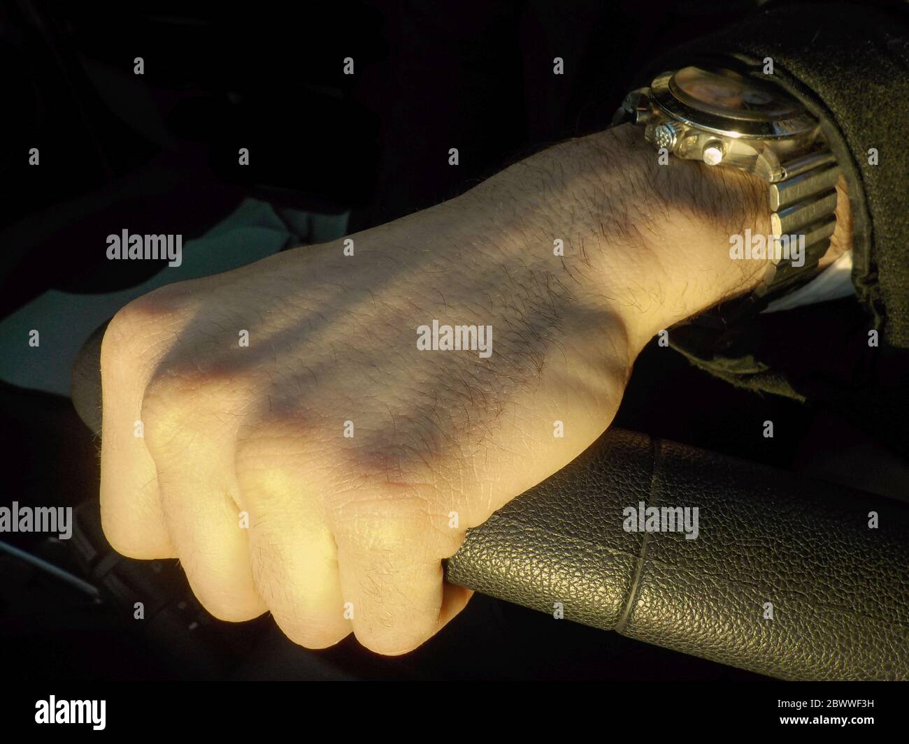Man hand on the steering wheel Stock Photo