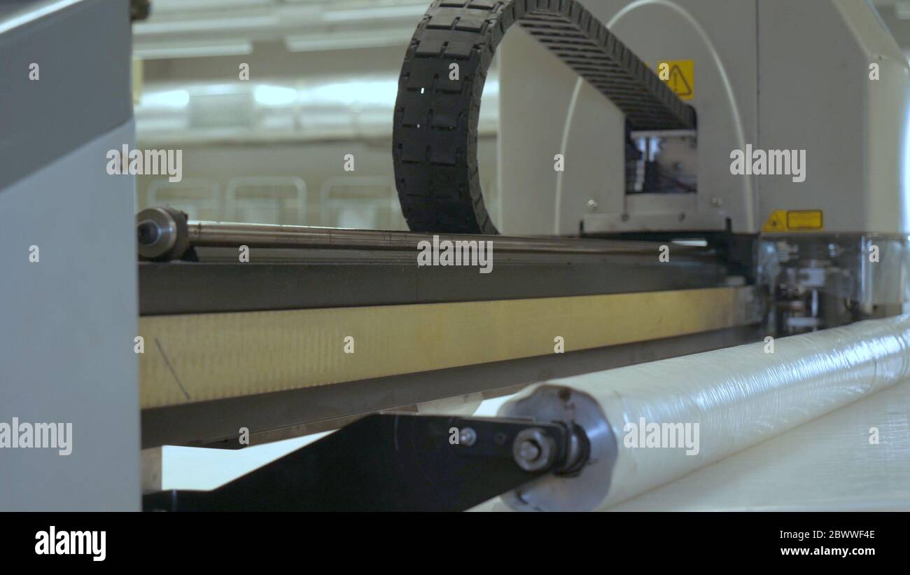 Industrial garment factory, an automatic sewing machine sews various strips on fabric offline