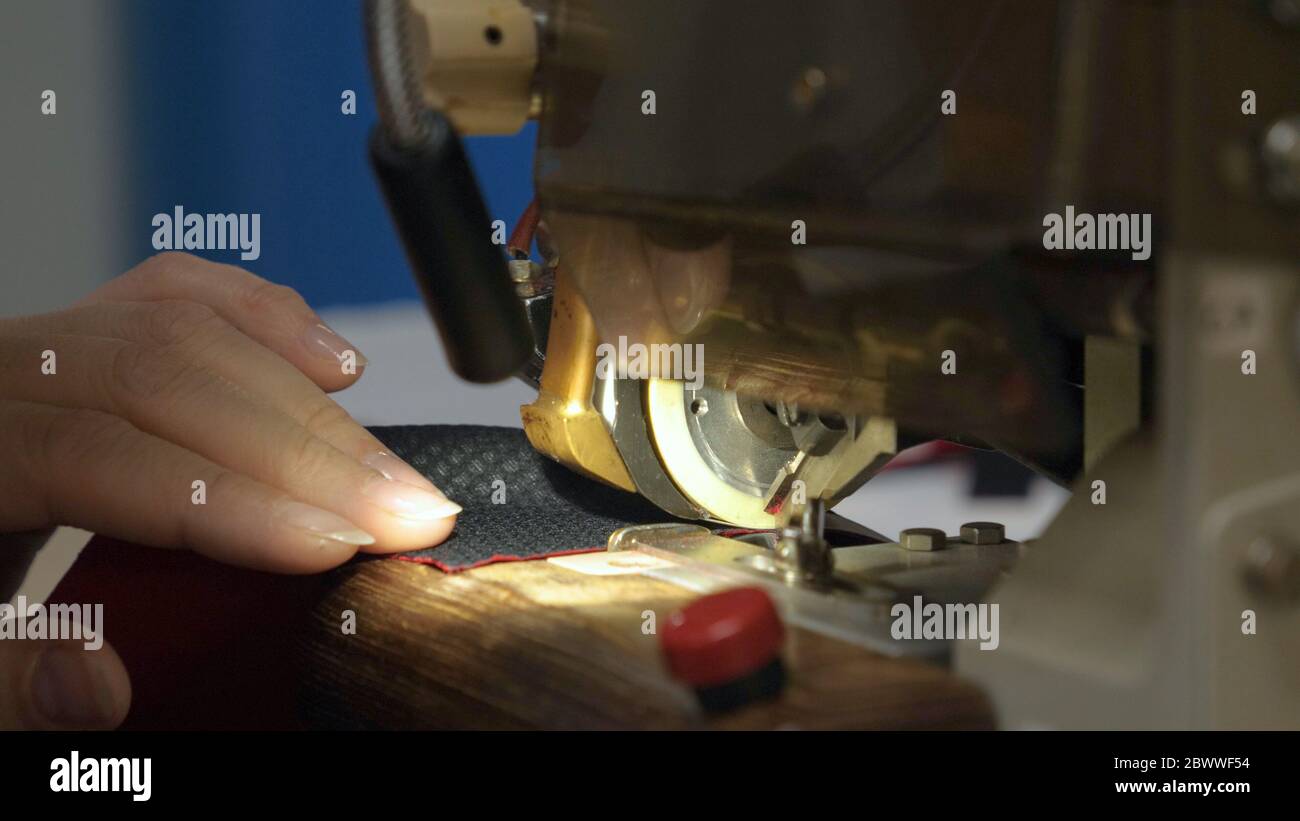 Industrial garment factory, an automatic sewing machine sews various ...