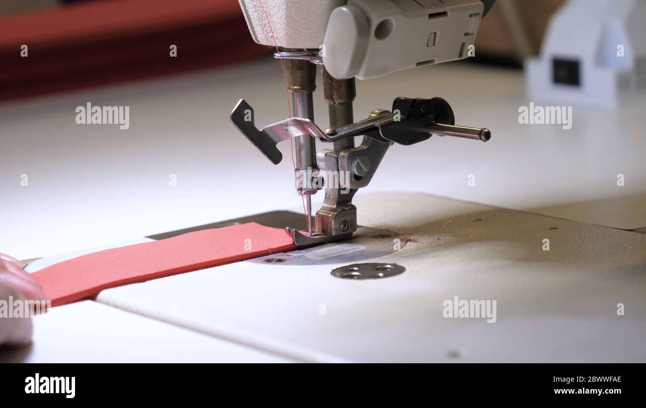 Industrial garment factory, an automatic sewing machine sews various ...