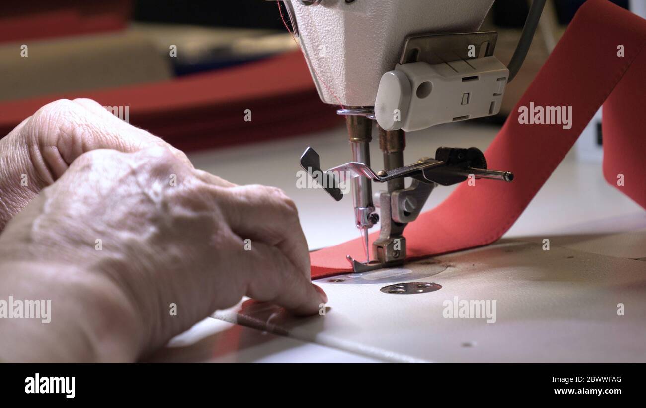 Industrial garment factory, an automatic sewing machine sews various ...