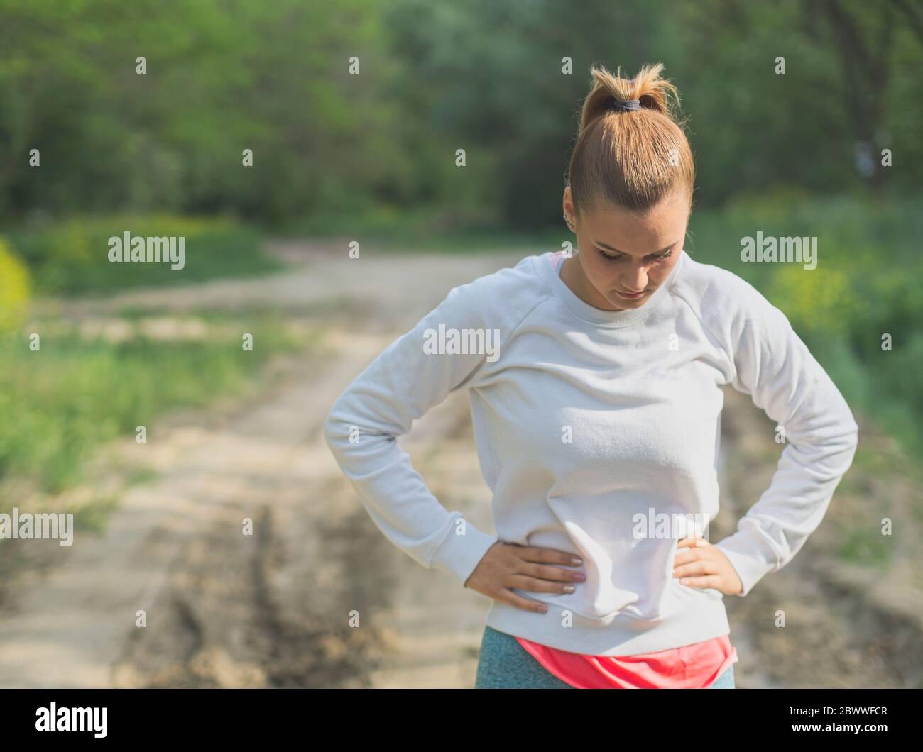 Young Blonde Caucasian Female Forest Runner Concentrating Stock Photo