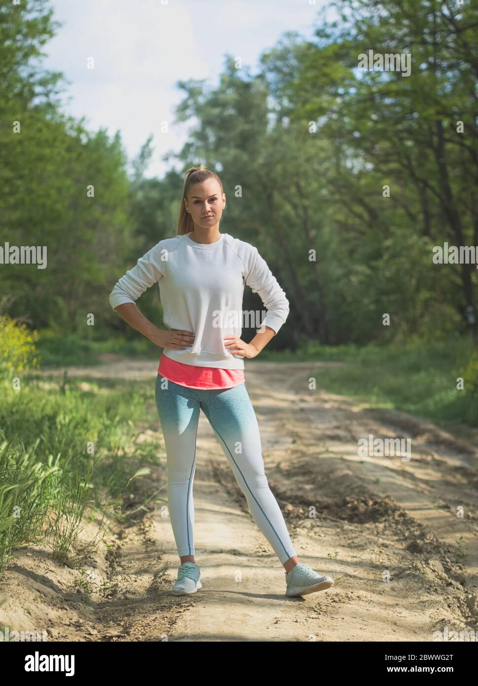 Young Blonde Caucasian Female Forest Runner Posing Stock Photo