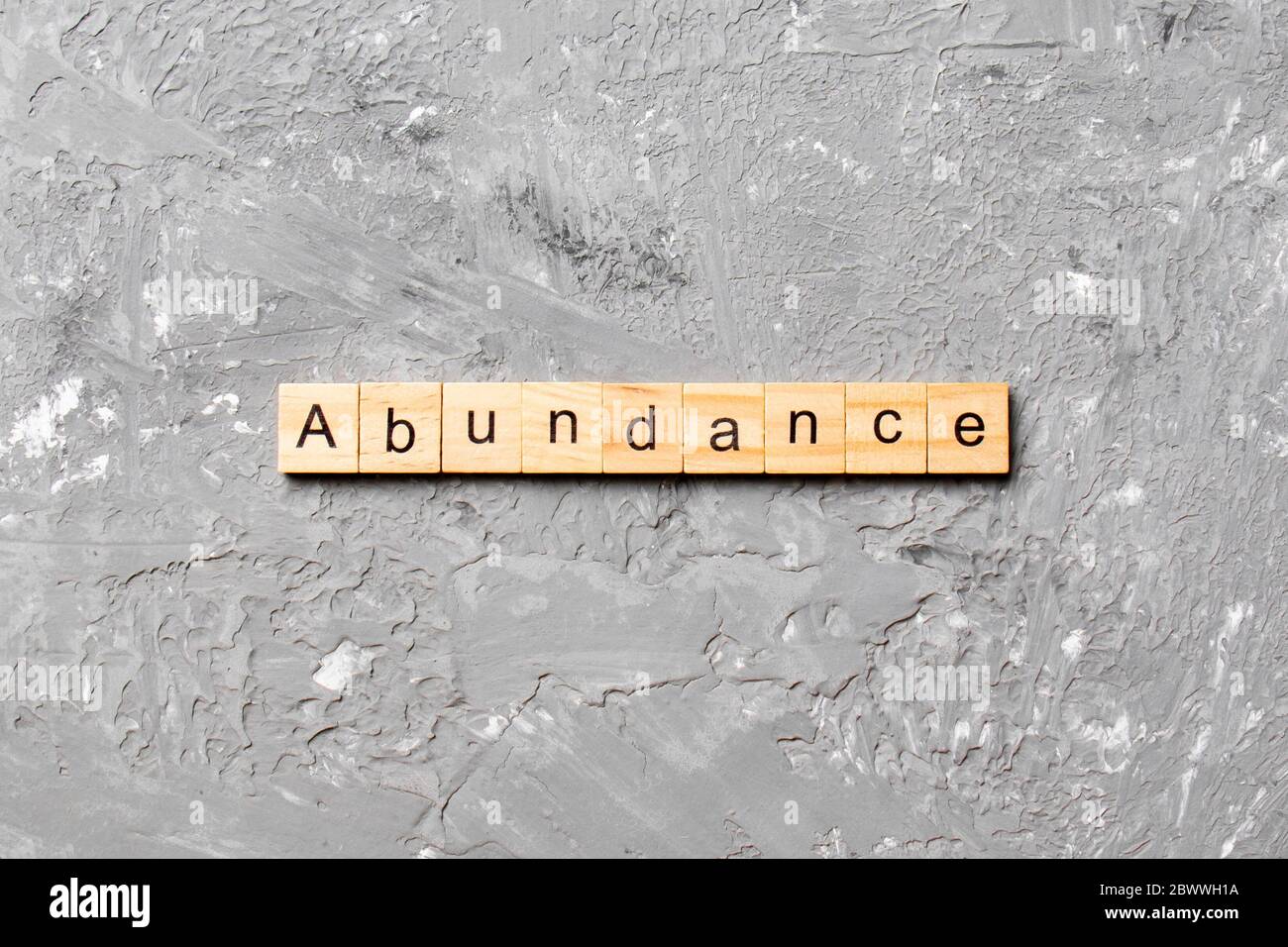 abundance word written on wood block. abundance text on table, concept. Stock Photo