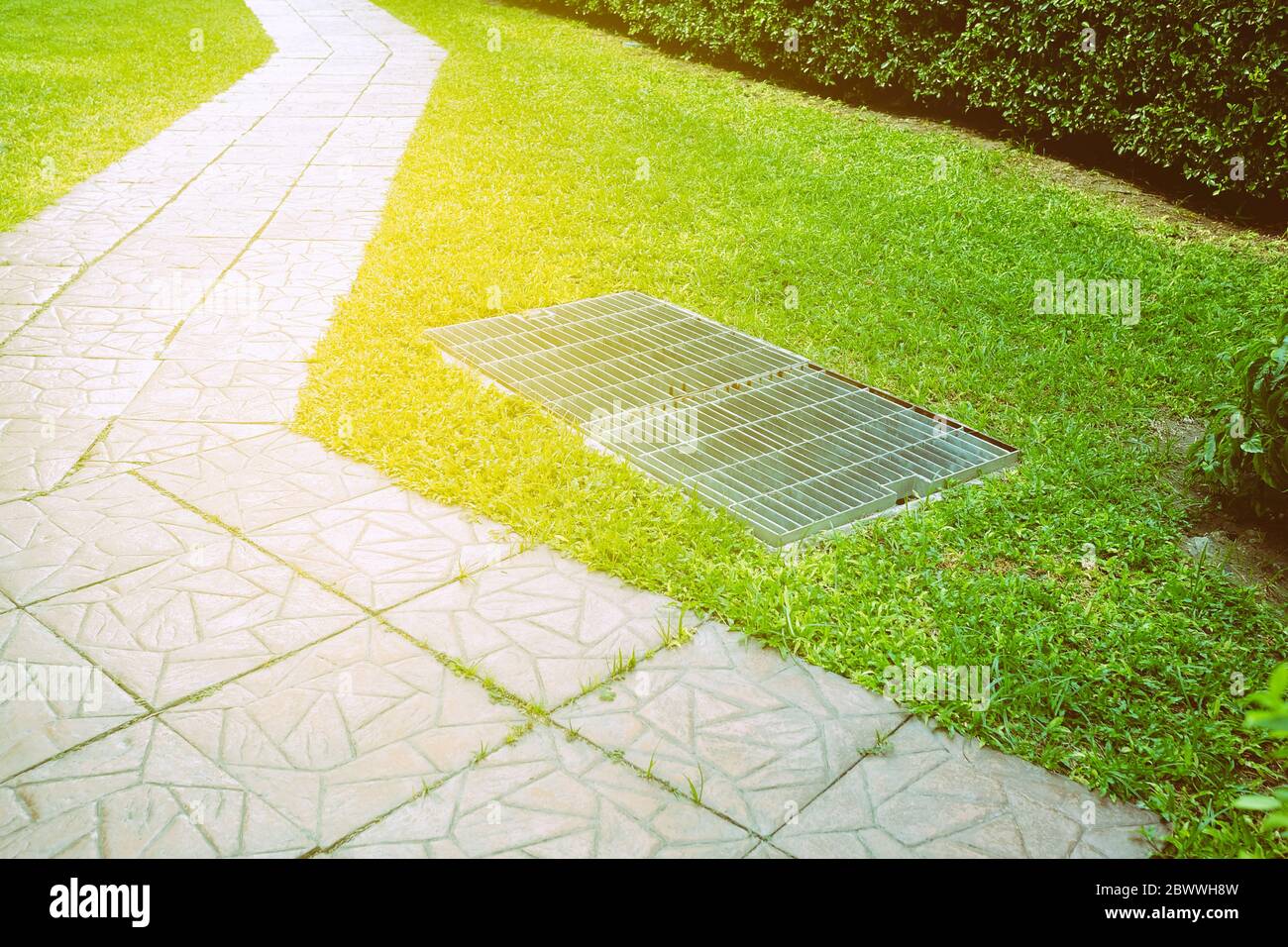 Pathway and Drainage in the  Garden with Light Leak. Stock Photo