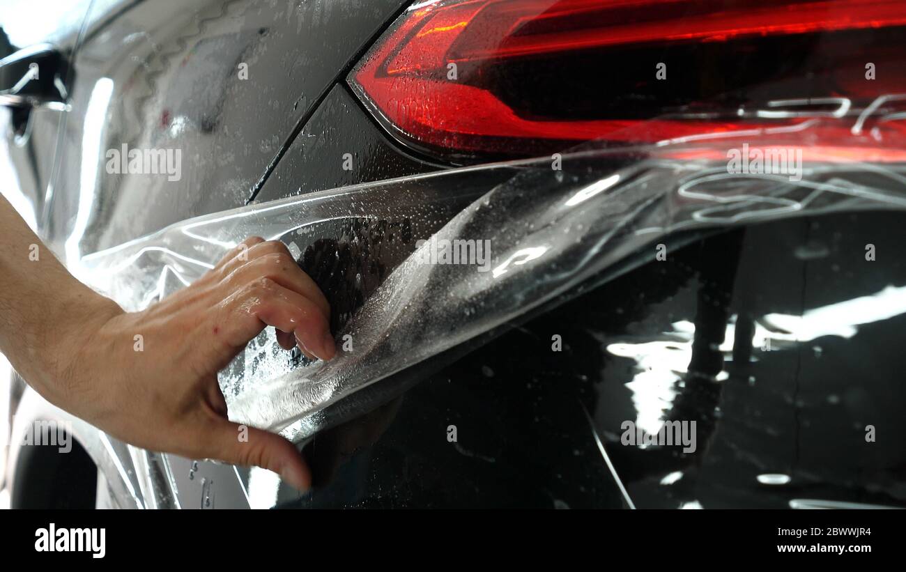 https://c8.alamy.com/comp/2BWWJR4/close-up-to-ppf-installation-process-on-a-front-headlight-and-hood-ppf-is-a-paint-protection-film-which-protect-paint-from-scratches-and-stone-chips-2BWWJR4.jpg