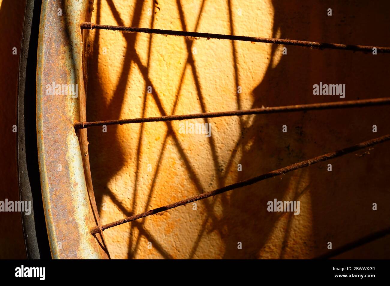 Old Bicycle Wheel with Shadow. Stock Photo