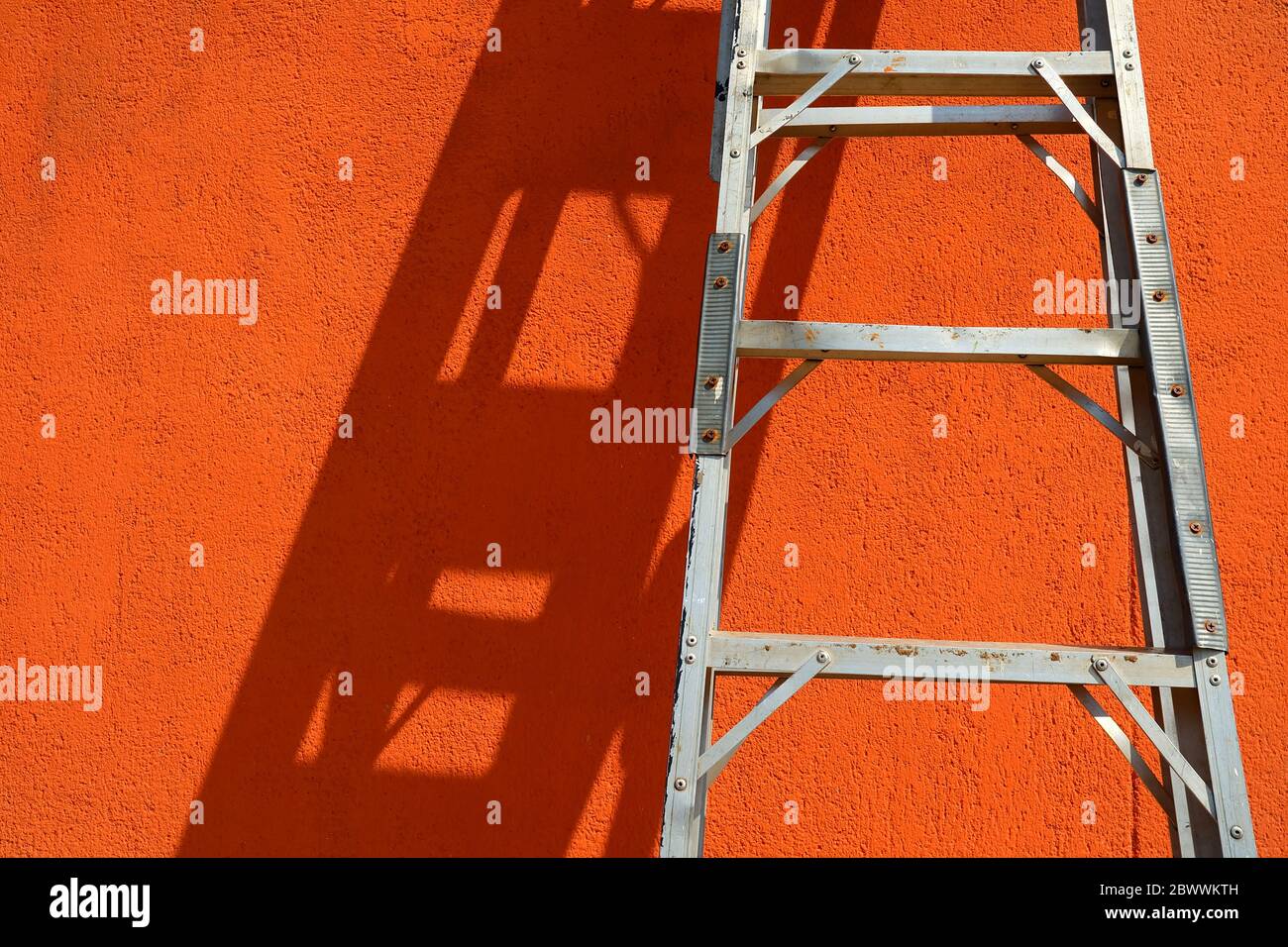 Stainless Ladder Leaning Against a Wall. Stock Photo
