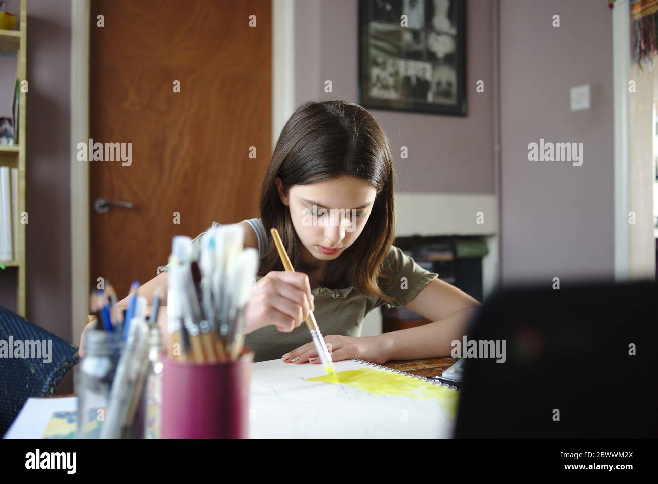 Young teenage girl participating in an online art class tutorial during coronavirus lockdown. May 2020 UK Stock Photo
