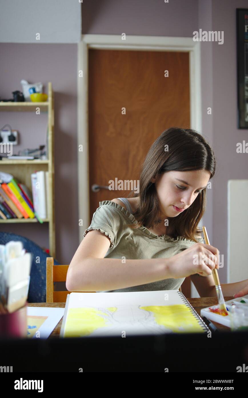 Young teenage girl participating in an online art class tutorial during coronavirus lockdown. May 2020 UK Stock Photo