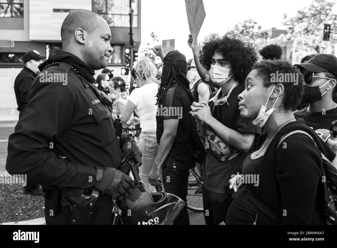 Oakland, Ca. 2nd June, 2020. A pregnant protestor speaks in sincerity to an Oakland Police Officer near the Oakland Police Department in Oakland, California on June 2, 2020 after the death of George Floyd. Credit: Chris Tuite/Image Space/Media Punch/Alamy Live News Stock Photo