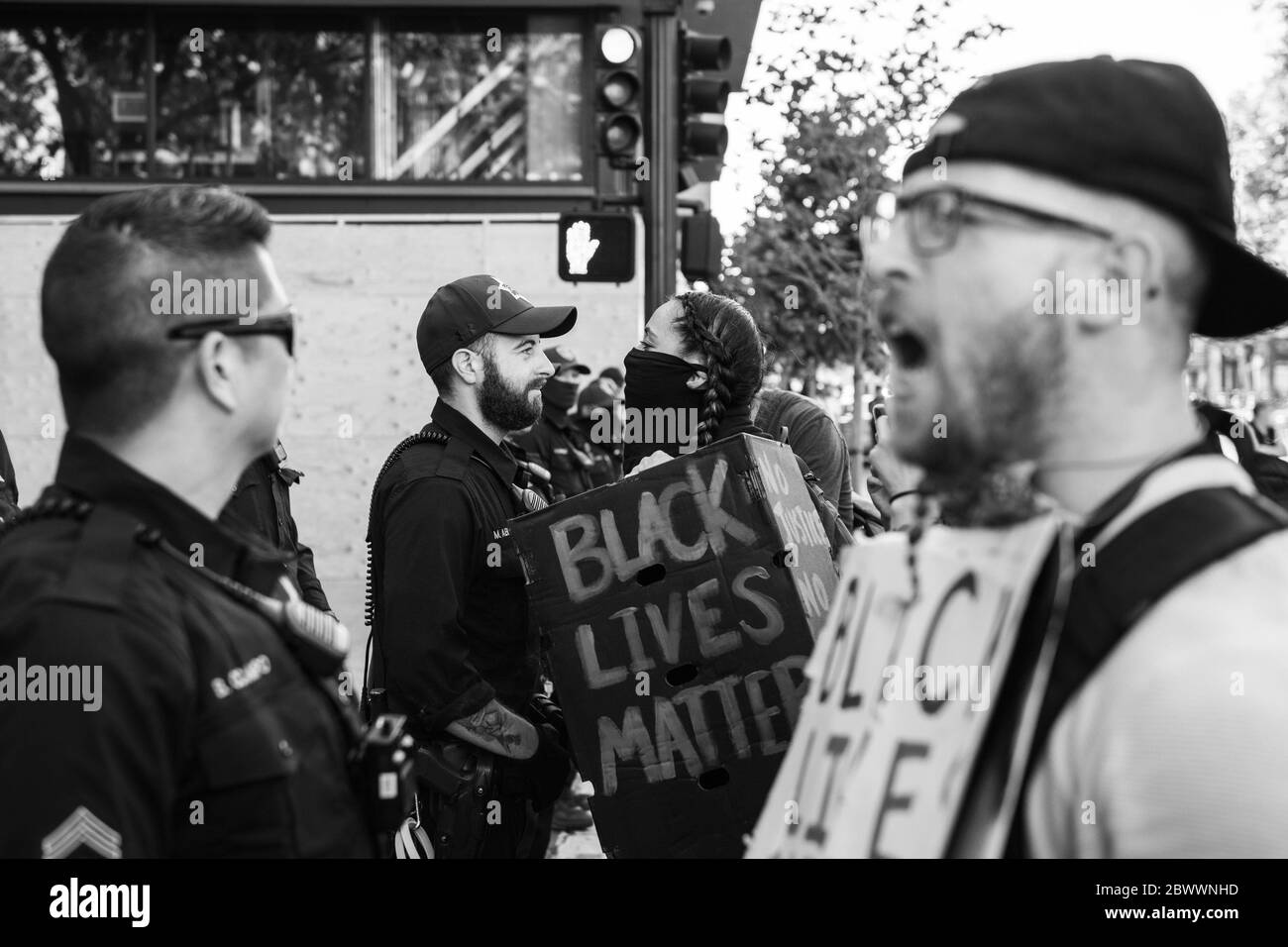 Oakland, Ca. 2nd June, 2020. An Oakland Police Officer and a protestor have a staredown near the Oakland Police Department in Oakland, California on June 2, 2020 after the death of George Floyd. Credit: Chris Tuite/Image Space/Media Punch/Alamy Live News Stock Photo